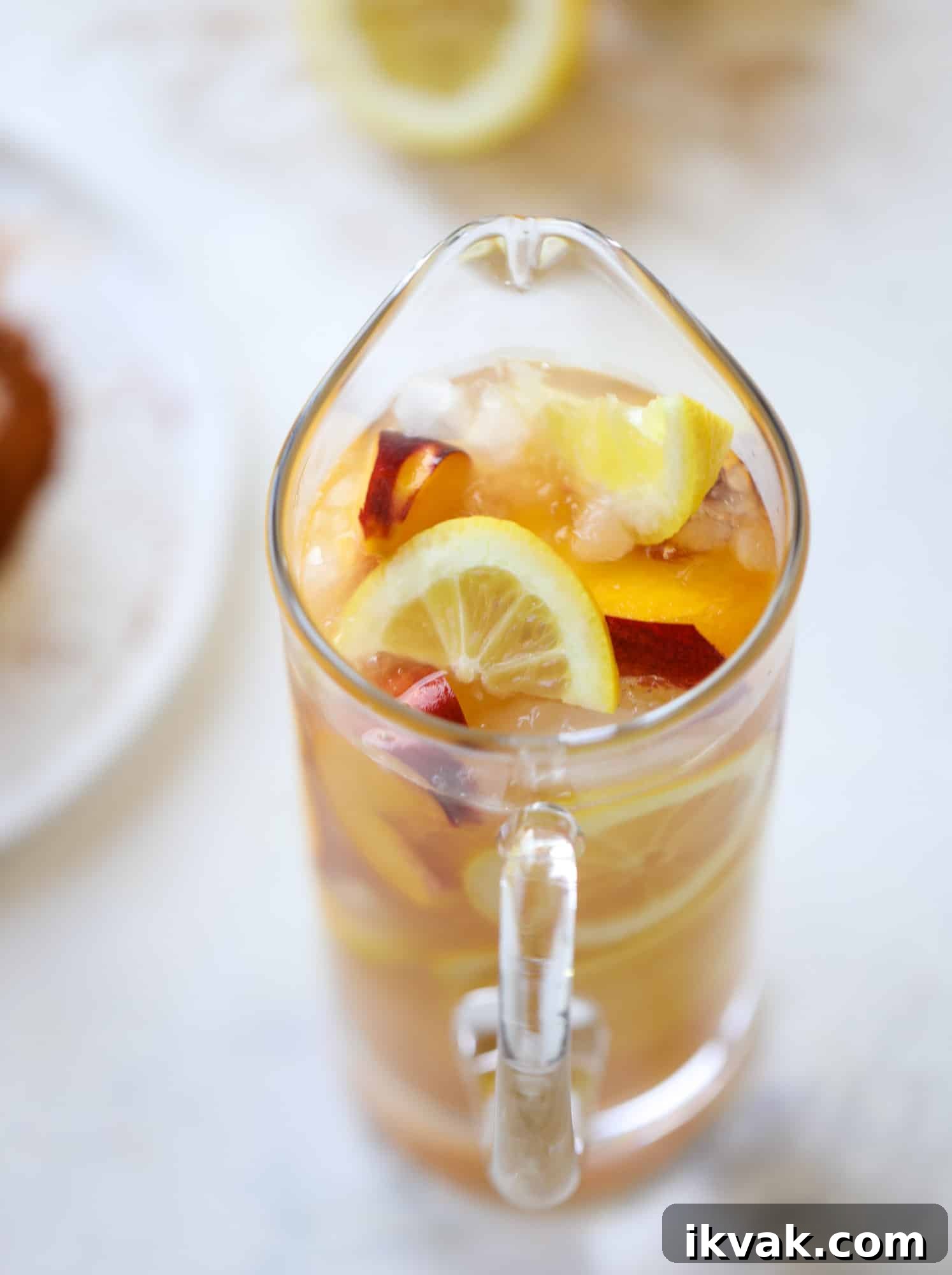 This peach lemonade is super refreshing and a bit spicy for a hot and sunny summer day. It's sweet and fresh and the rim is dipped in a cajun seasoning, bringing the best bite of heat to this perfect summer drink. So fresh! I howsweeteats.com #peach #lemonade #cajun #summer #mocktail #lemon #drink