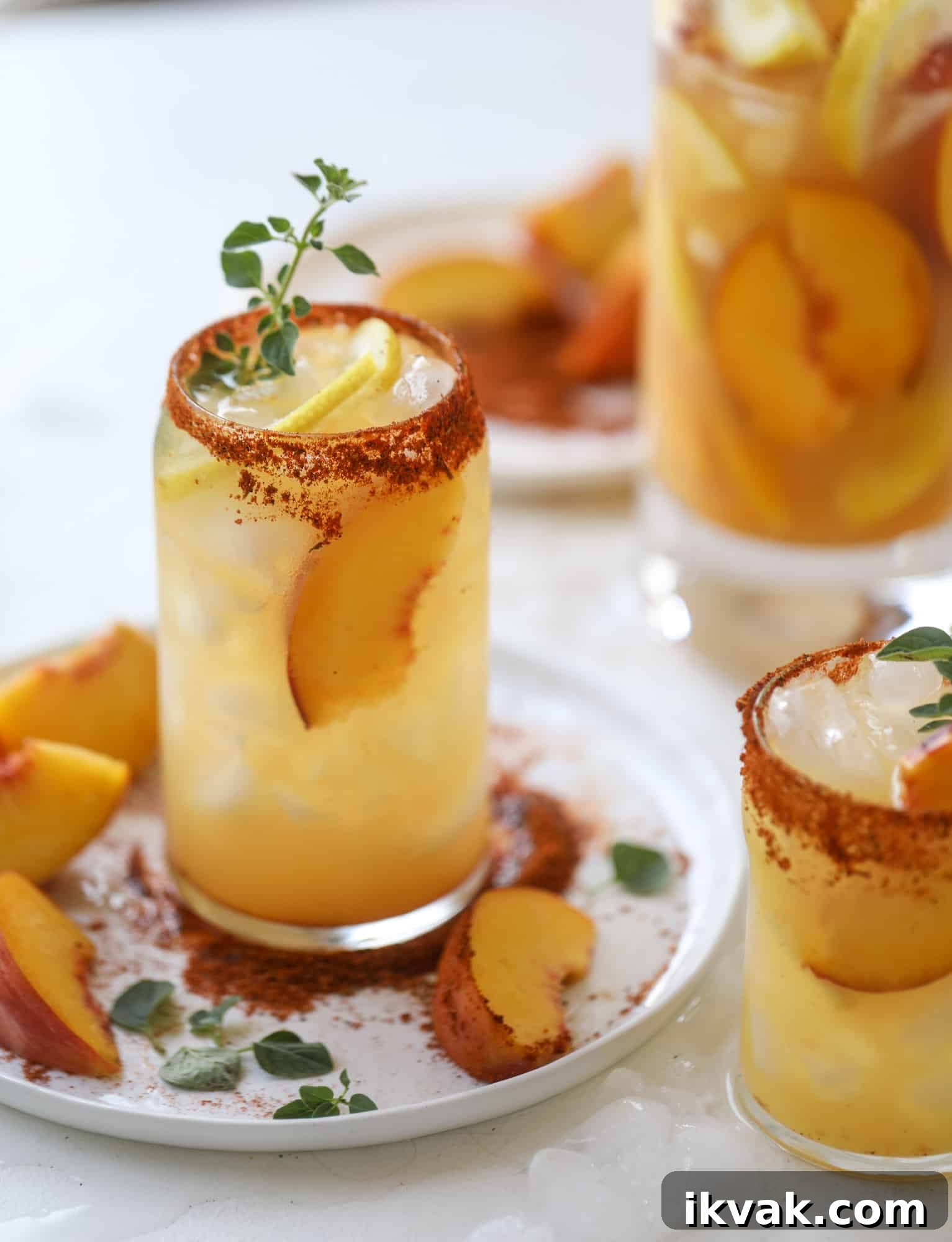 This peach lemonade is super refreshing and a bit spicy for a hot and sunny summer day. It's sweet and fresh and the rim is dipped in a cajun seasoning, bringing the best bite of heat to this perfect summer drink. So fresh! I howsweeteats.com #peach #lemonade #cajun #summer #mocktail #lemon #drink