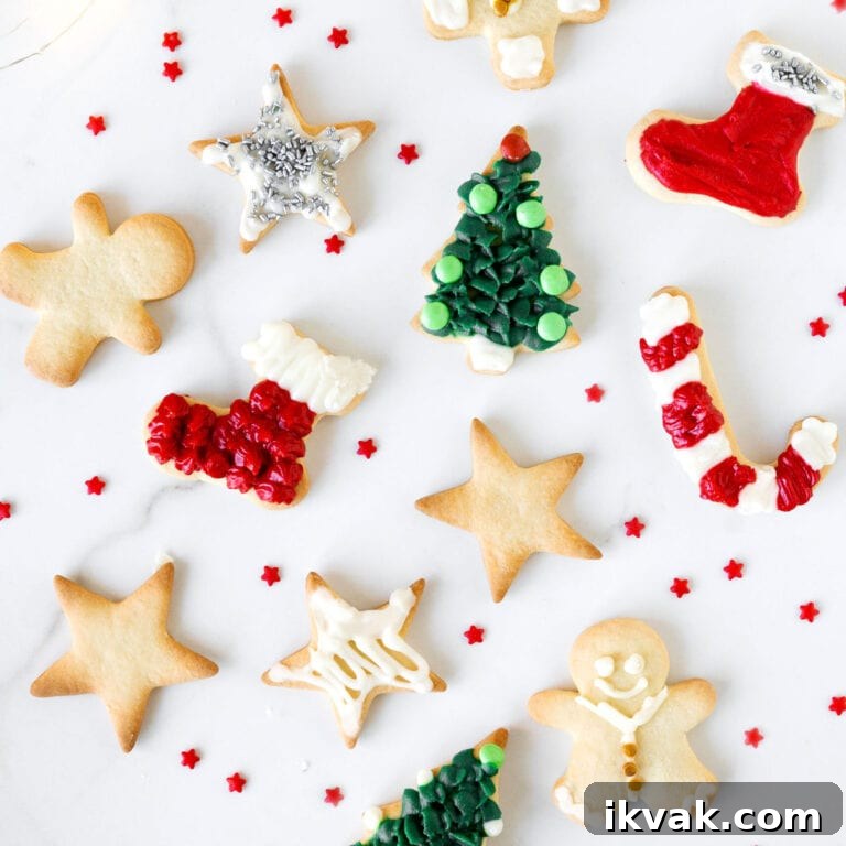 White marbled surface with decorated and plain holiday cut out cookies.