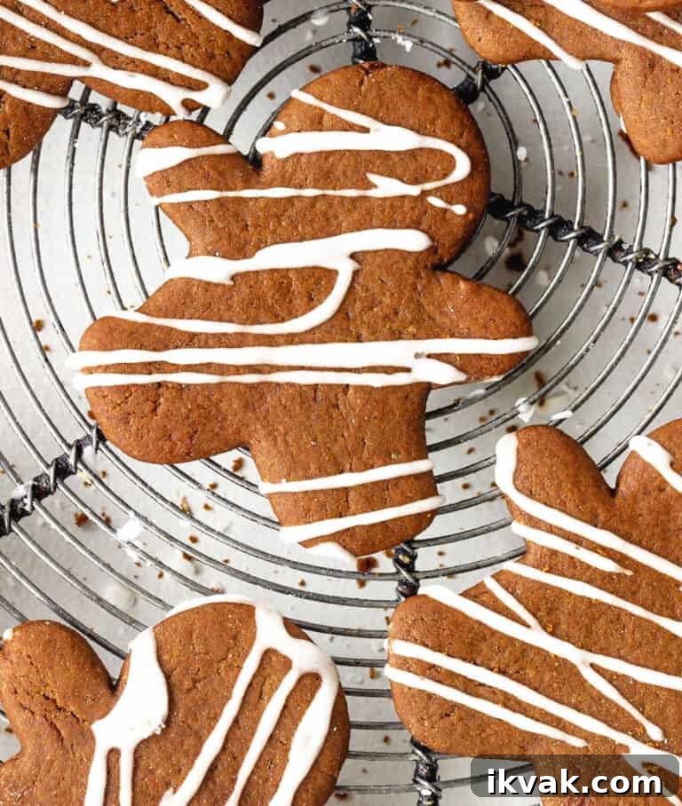Close up aerial view of iced gingerbread people on a metal wire rack.