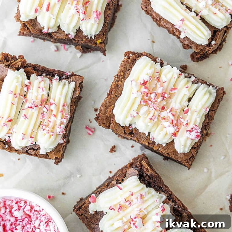 Close up brownies with cream cheese peppermint topping on white marble.