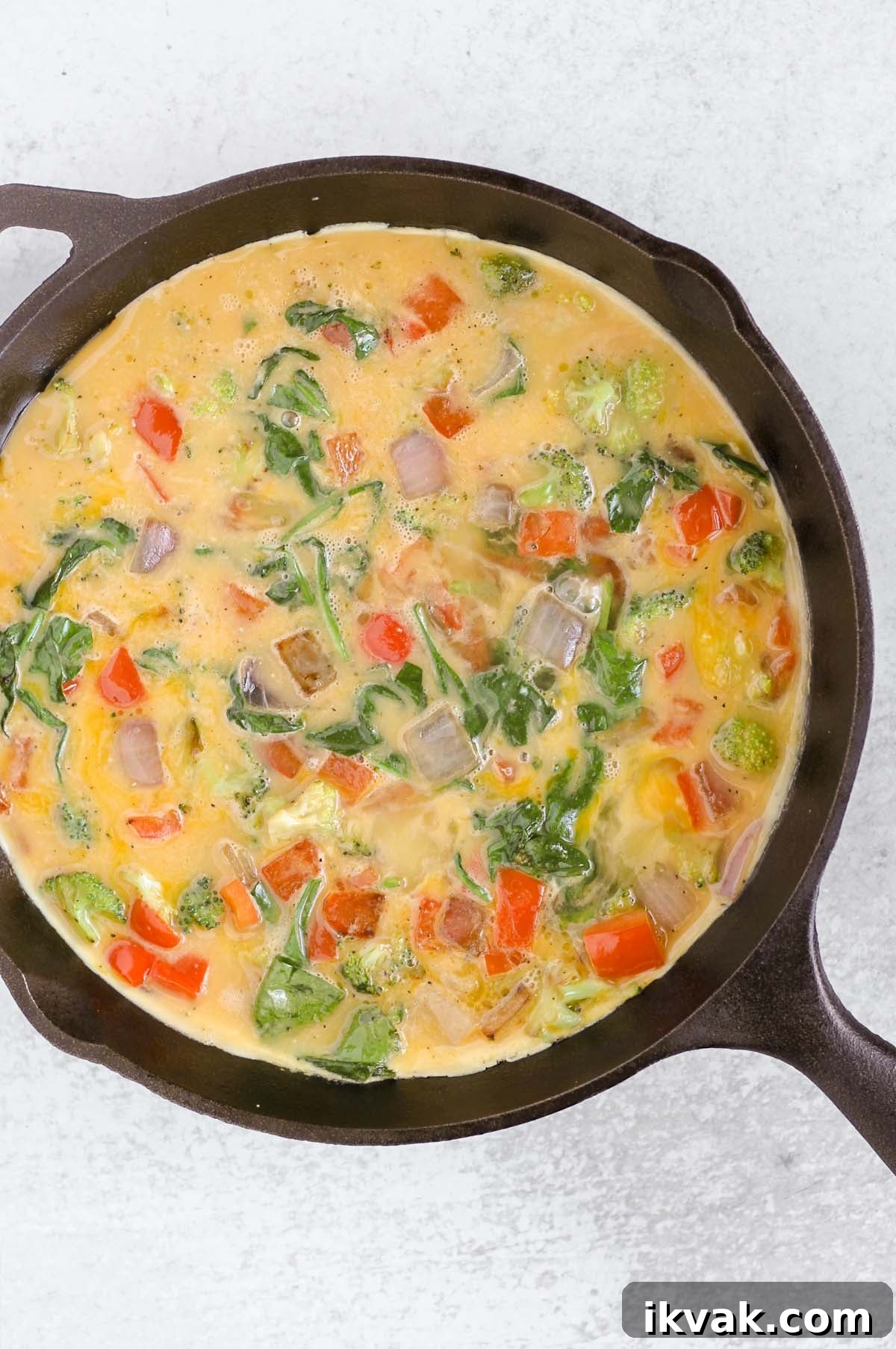 Dairy-Free Vegetable Frittata Gluten-Free Breakfast Recipe 6 Whisked eggs mixed with veggies in a cast iron skillet.