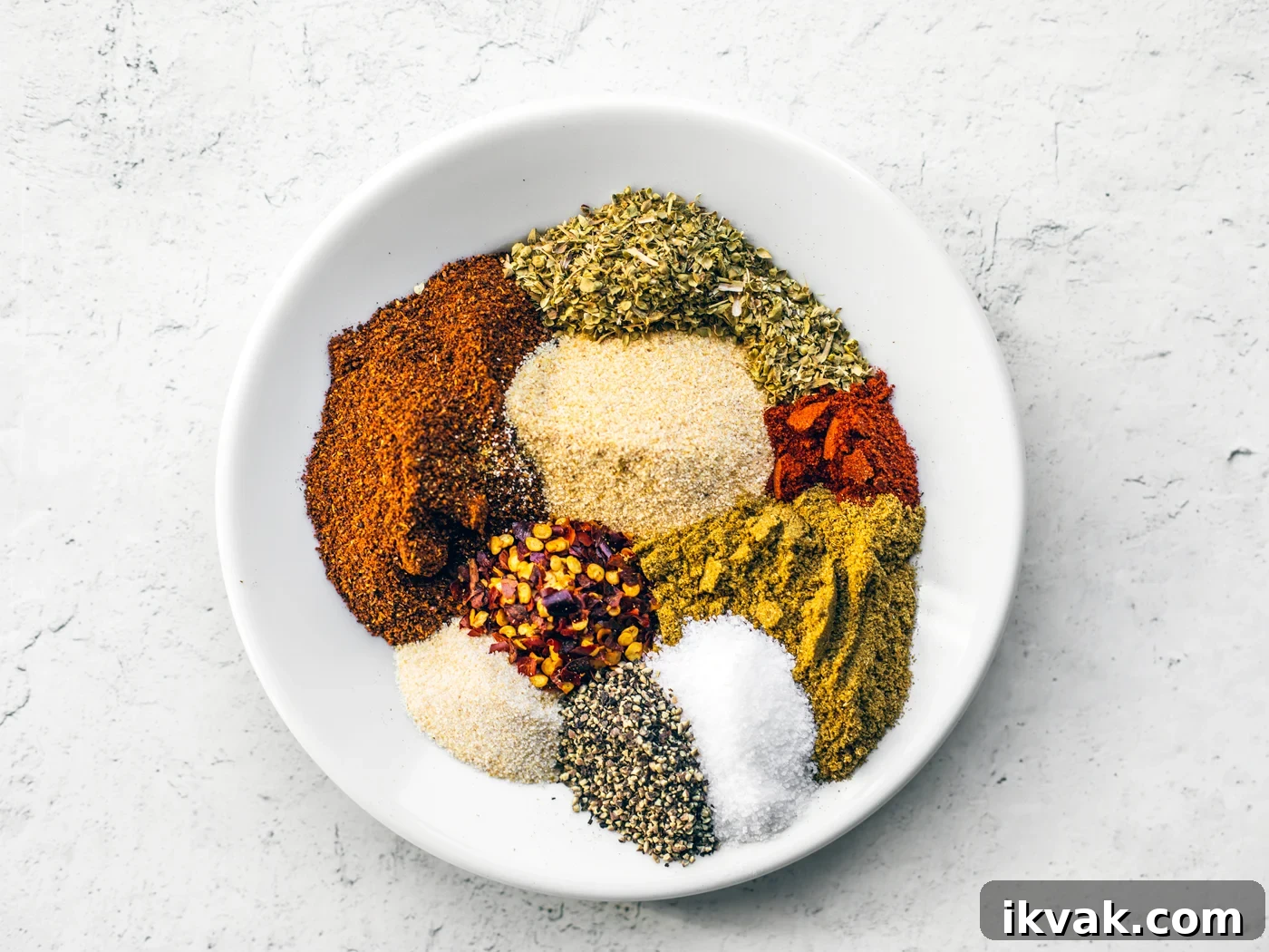 Small plate full of unmixed dried spices.