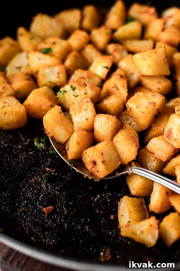 Crispy Skillet Breakfast Potatoes with Garlic and Herbs 2 breakfast potatoes in cast iron skillet