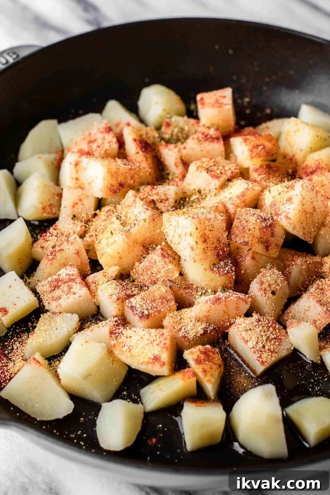 Crispy Skillet Breakfast Potatoes with Garlic and Herbs 5 breakfast potatoes boiled potatoes and spices combined in bowl