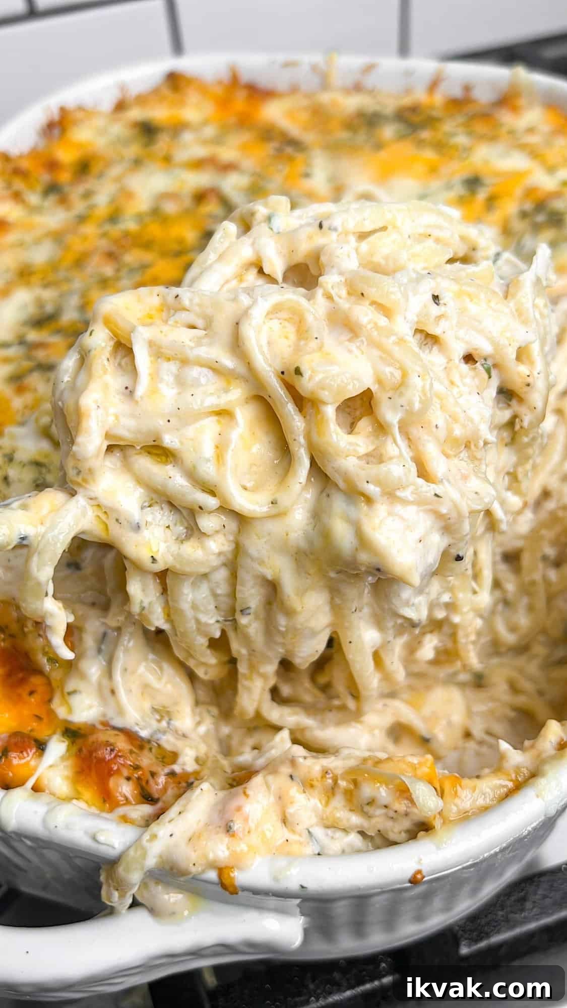Lusciously creamy, cheesy, and garlicky, this easy chicken tetrazzini can be whipped up in under an hour for an easy weeknight dinner. Lifting a serving of chicken tetrazzini from the casserole dish