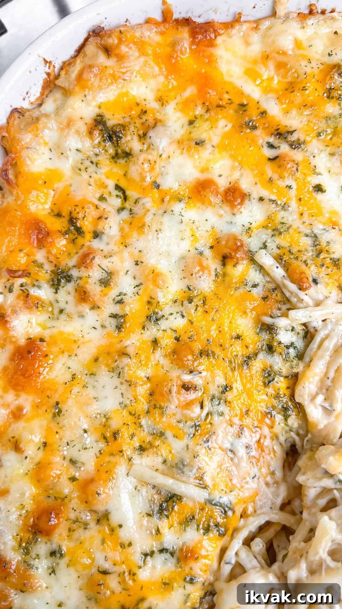 Lusciously creamy, cheesy, and garlicky, this easy chicken tetrazzini can be whipped up in under an hour for an easy weeknight dinner. Overhead view of a baking dish of chicken tetrazzini