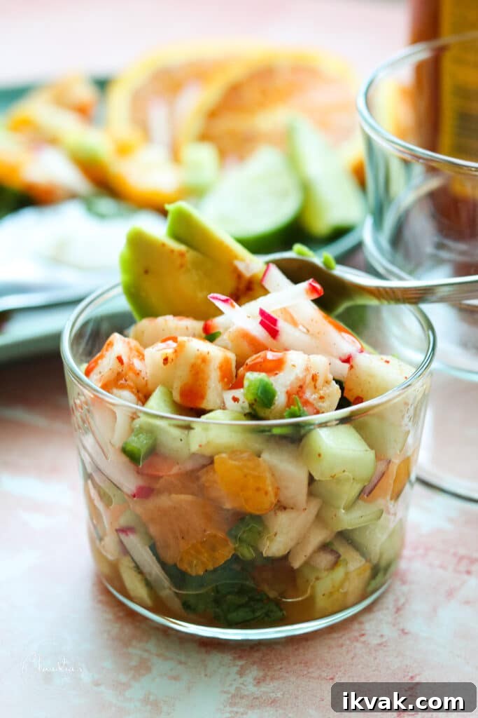 shrimp and avocado salad in small cup with avocado