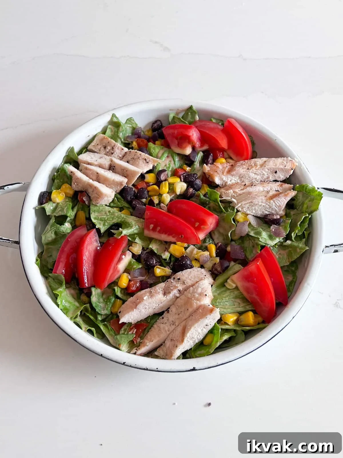 Tomatoes added to the top of the salad.