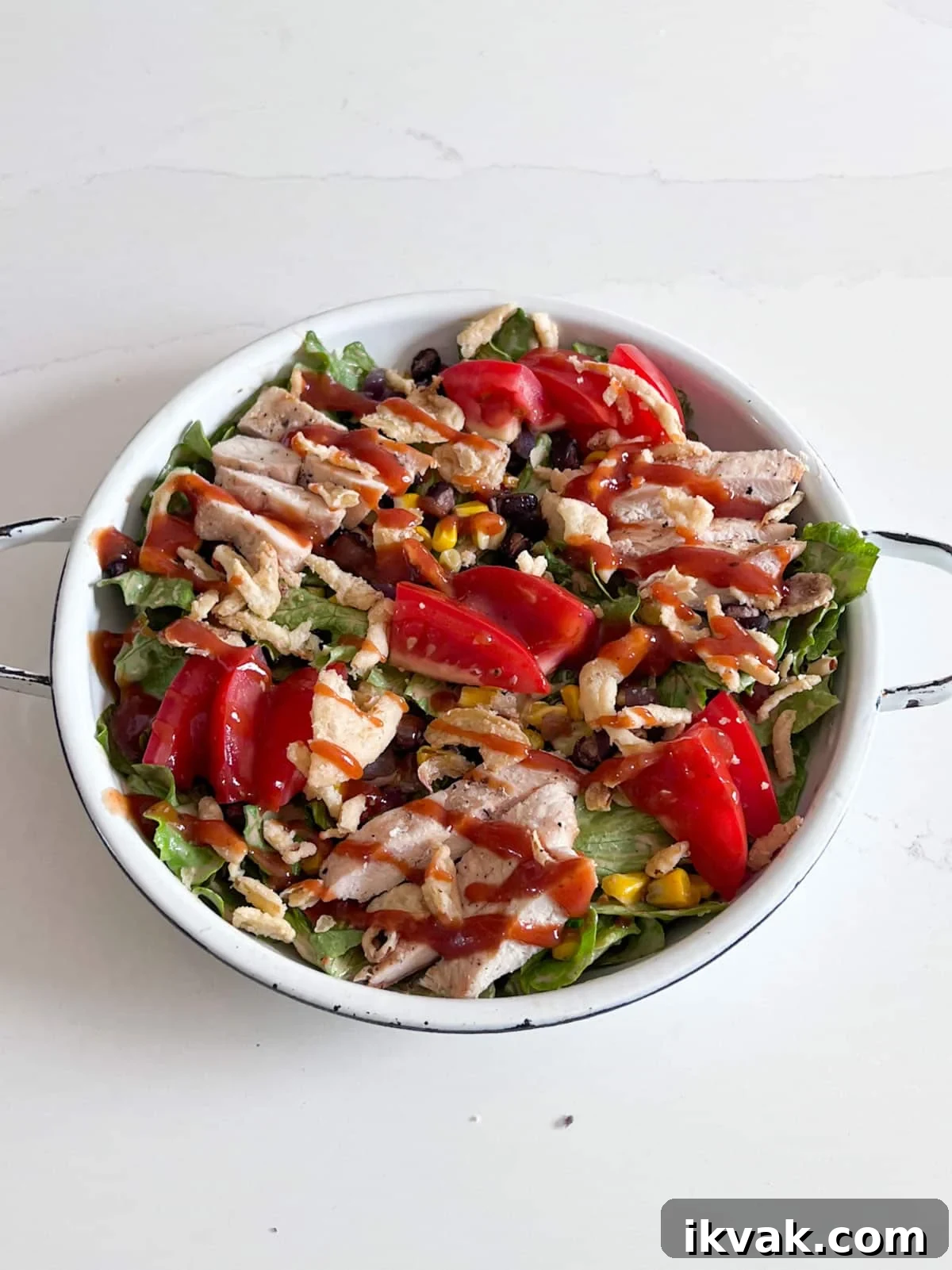 BBQ sauce and fried onions added to the top of the salad.