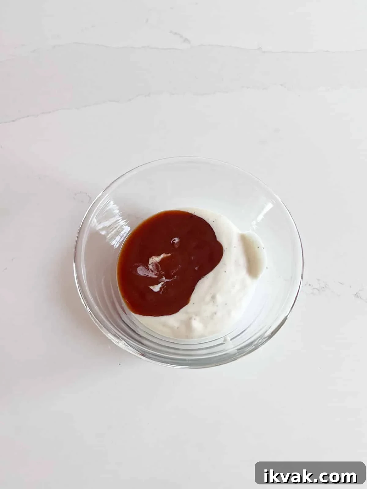 Dressing ingredients in a glass bowl.