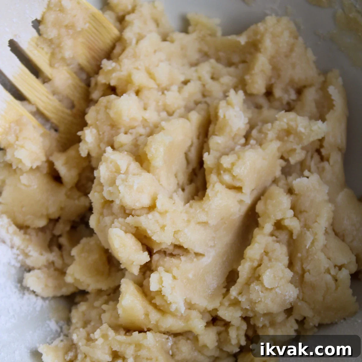 Added melted butter and almond extract to form a dough in the mixing bowl.