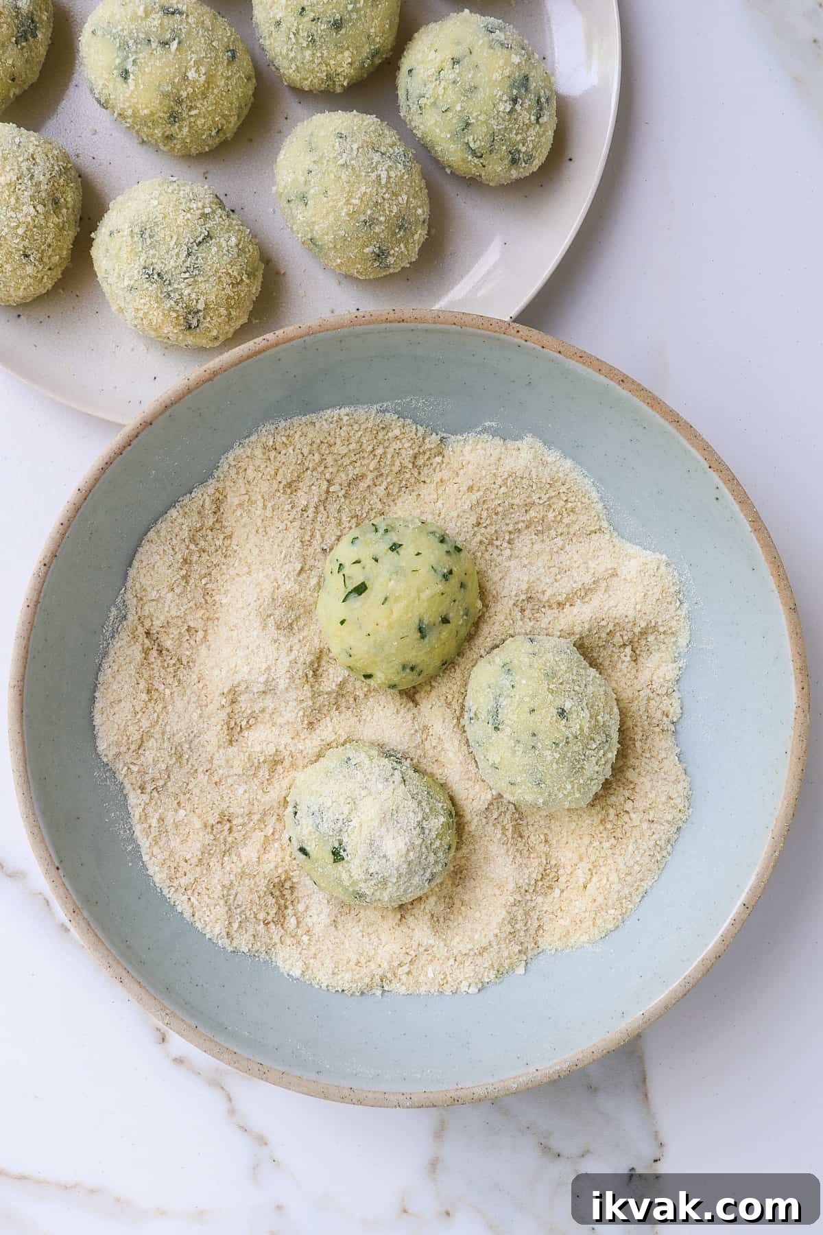 Crispy Air Fryer Potato Croquettes Recipe 7 Potato croquettes getting rolled in breadcrumbs.