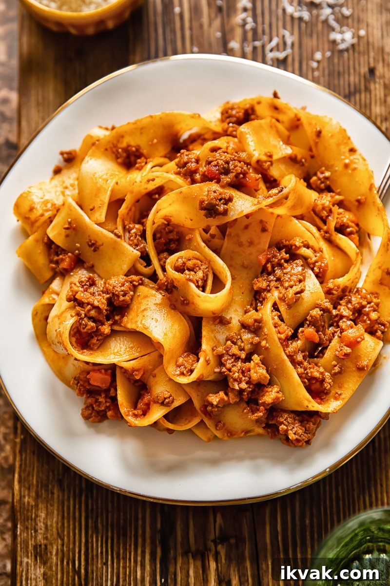 pappardelle with meaty tomato sauce on a white plate