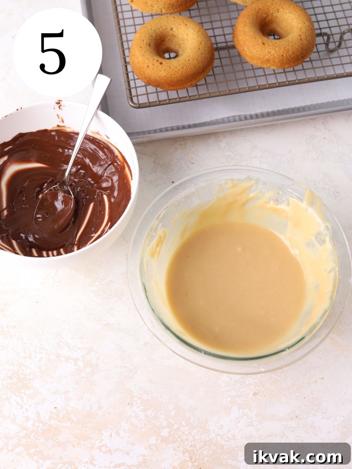Irresistible Peanut Butter Donuts Recipe — Soft, Gooey, Homemade 8 A bowl of peanut butter icing, a bowl of melted chocolate and some donuts.
