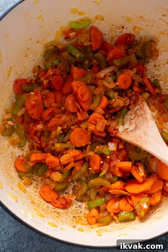 Blooming the spices and sautéing  vegetables with tomato paste in a Dutch oven.