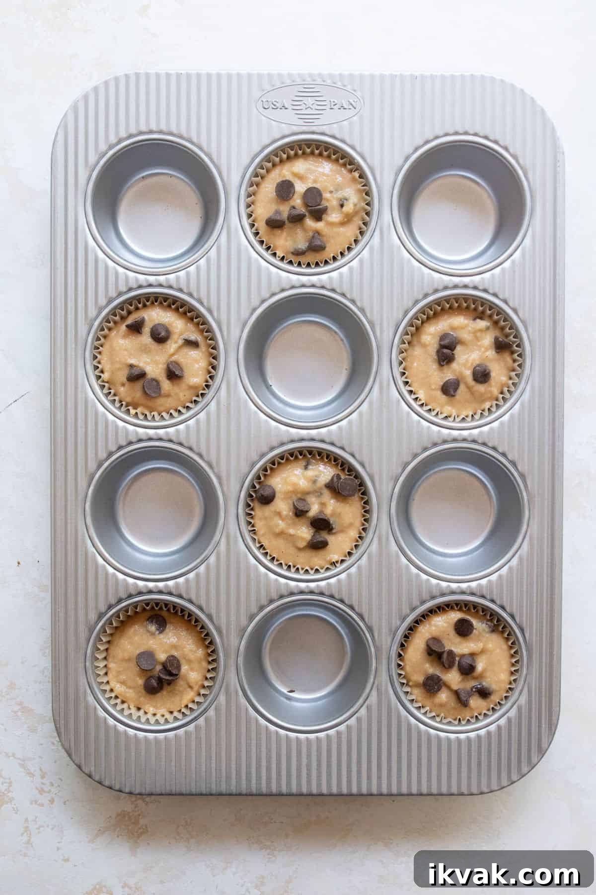 High-Protein Banana Muffins for Breakfast and Snacks 8 Banana protein muffin batter scooped into a muffin tin and ready to bake.
