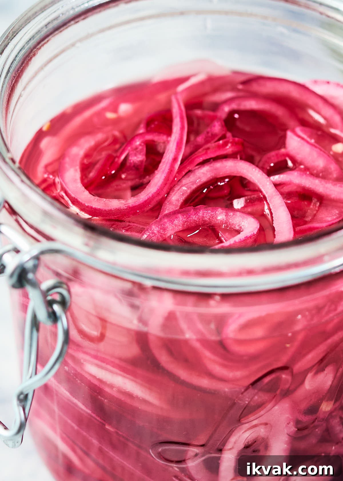 Quick pickled red onions in a glass mason jar.