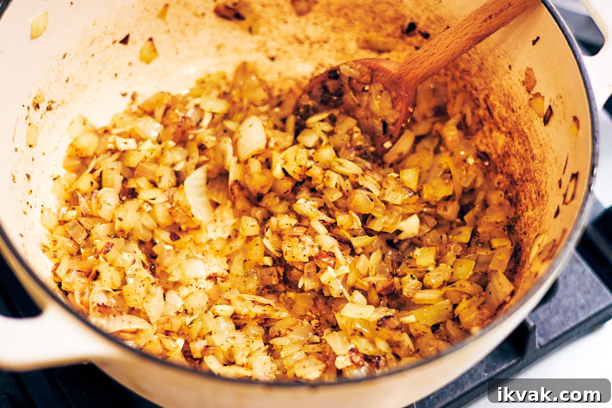 Cooking onions and spices in a pot for soup.
