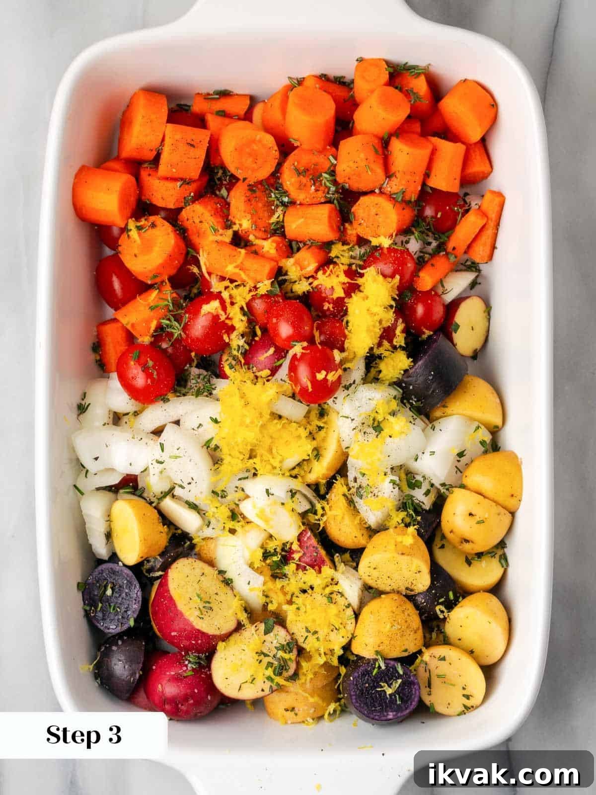 vegetables sliced in white baking dish.