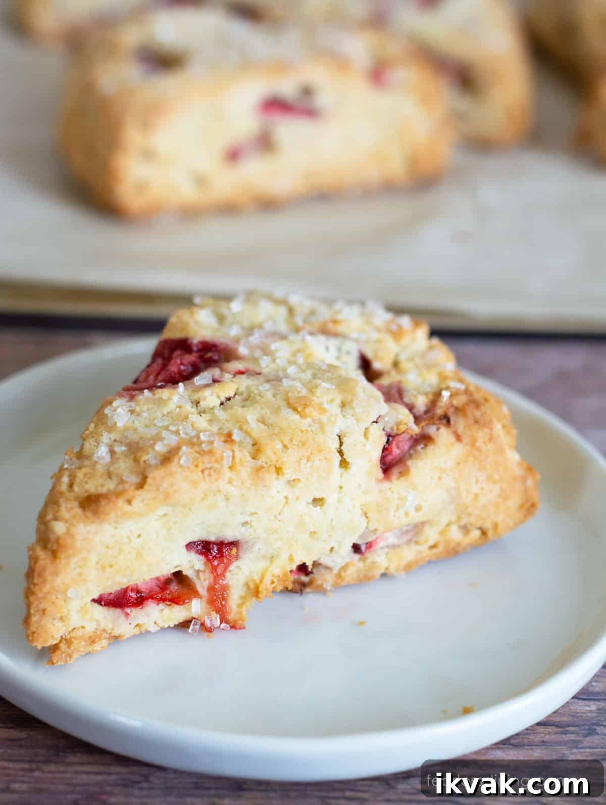 Gluten-Free Strawberries & Cream Scones Recipe for Brunch 3 A gluten free strawberries and cream scone on a small white plate.