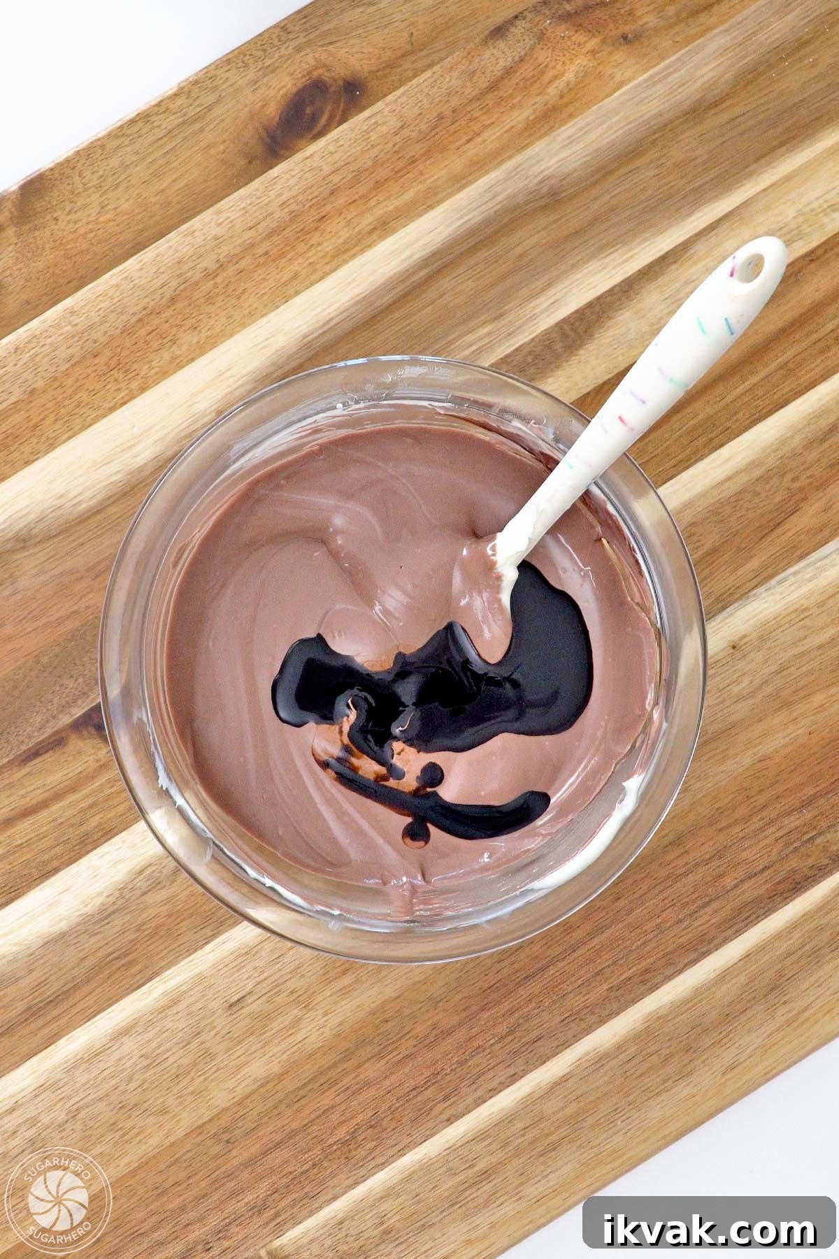 Root beer float flavoring added to a bowl of melted brown candy coating.