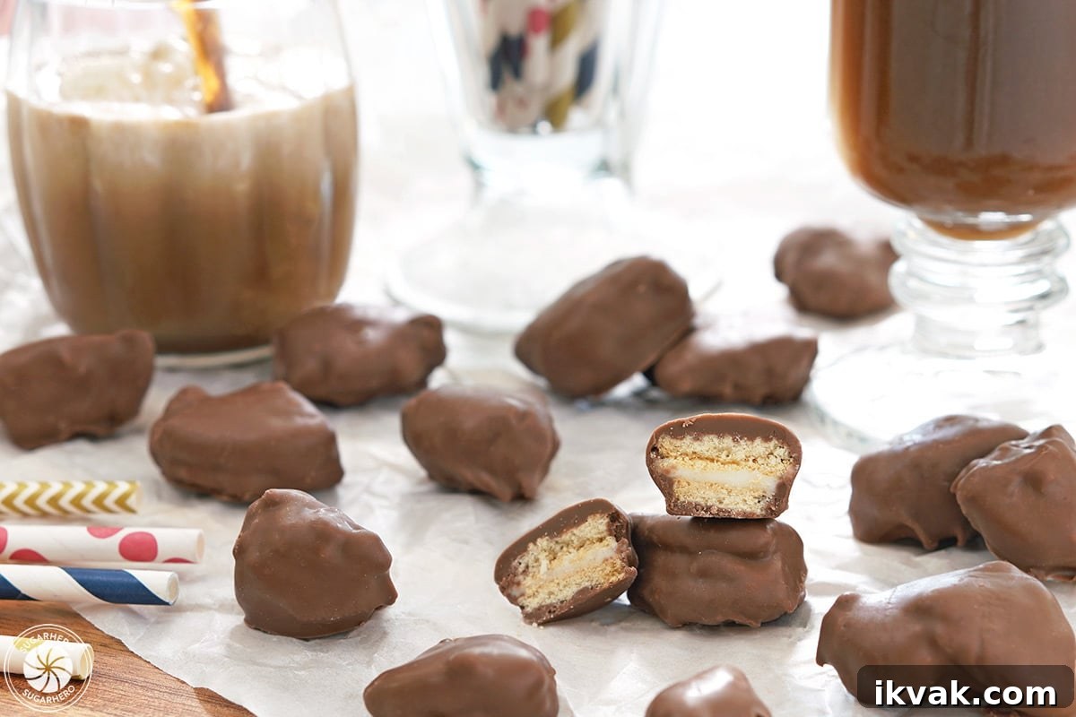 Homemade Root Beer Float Pieces scattered on white parchment, with one cut open to show the inside.