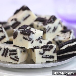 Several pieces of Oreo fudge cut in cubes on a silver plate.