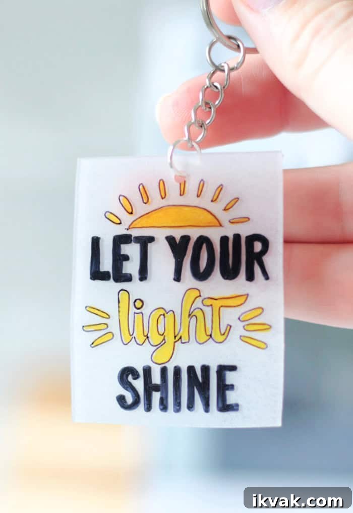 shrinky dink keychain with "let your light shine" phrase on the front