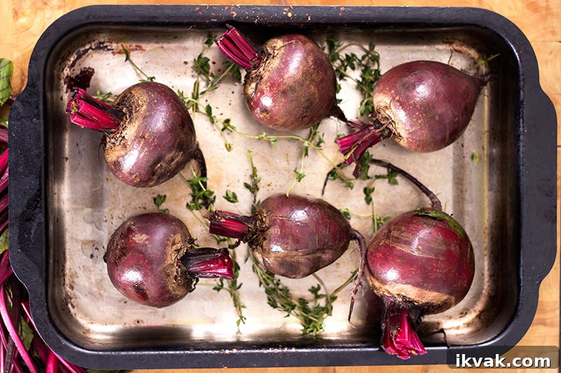Trimmend beetroot with thyme in roasting tin