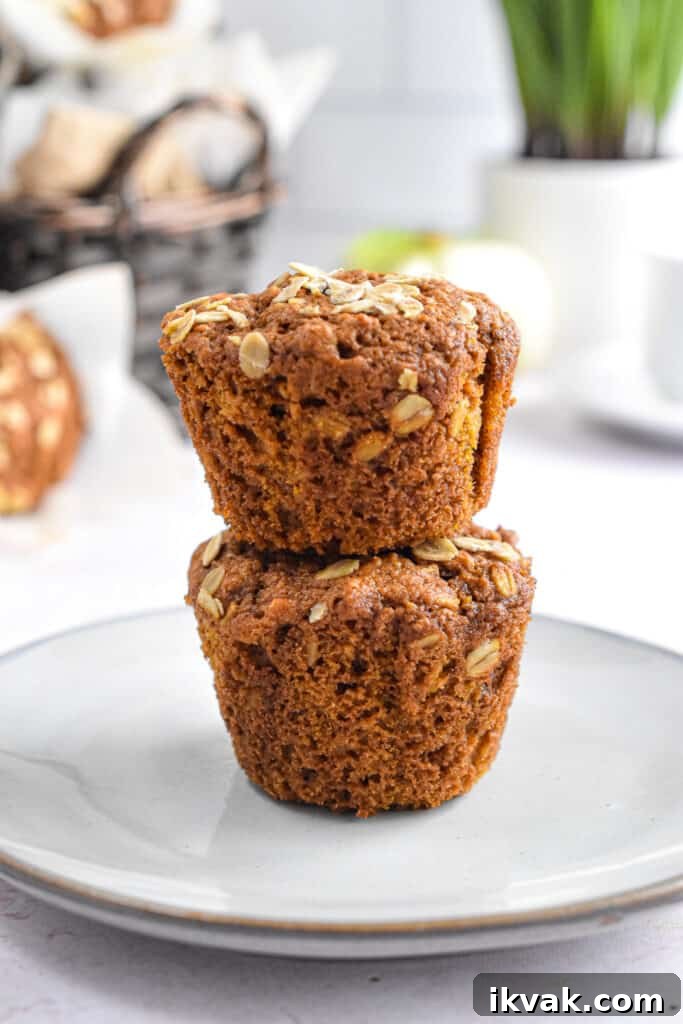 Pumpkin Oatmeal Muffins with Warm Spices and Maple Glaze 2 Two muffins are stacked on top of each other.
