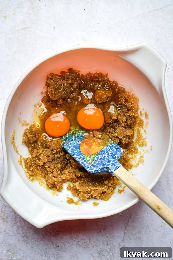 Pumpkin Oatmeal Muffins with Warm Spices and Maple Glaze 7 The eggs are added