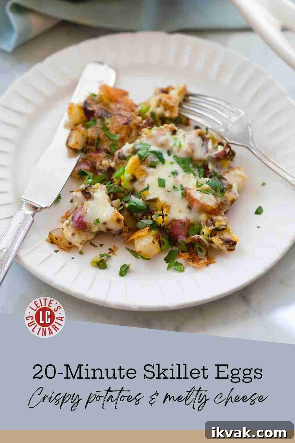 Crispy red potatoes and fluffy scrambled eggs topped with melted cheese and parsley on a white plate.