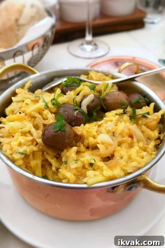 A copper pot of bacalhau a Bras--or Portuguese scrambled eggs, salt cod, potatoes, onions, olives, and parsley.