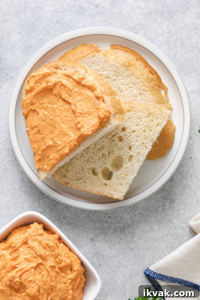 Top down view of cream cheese spread over a piece of bread.