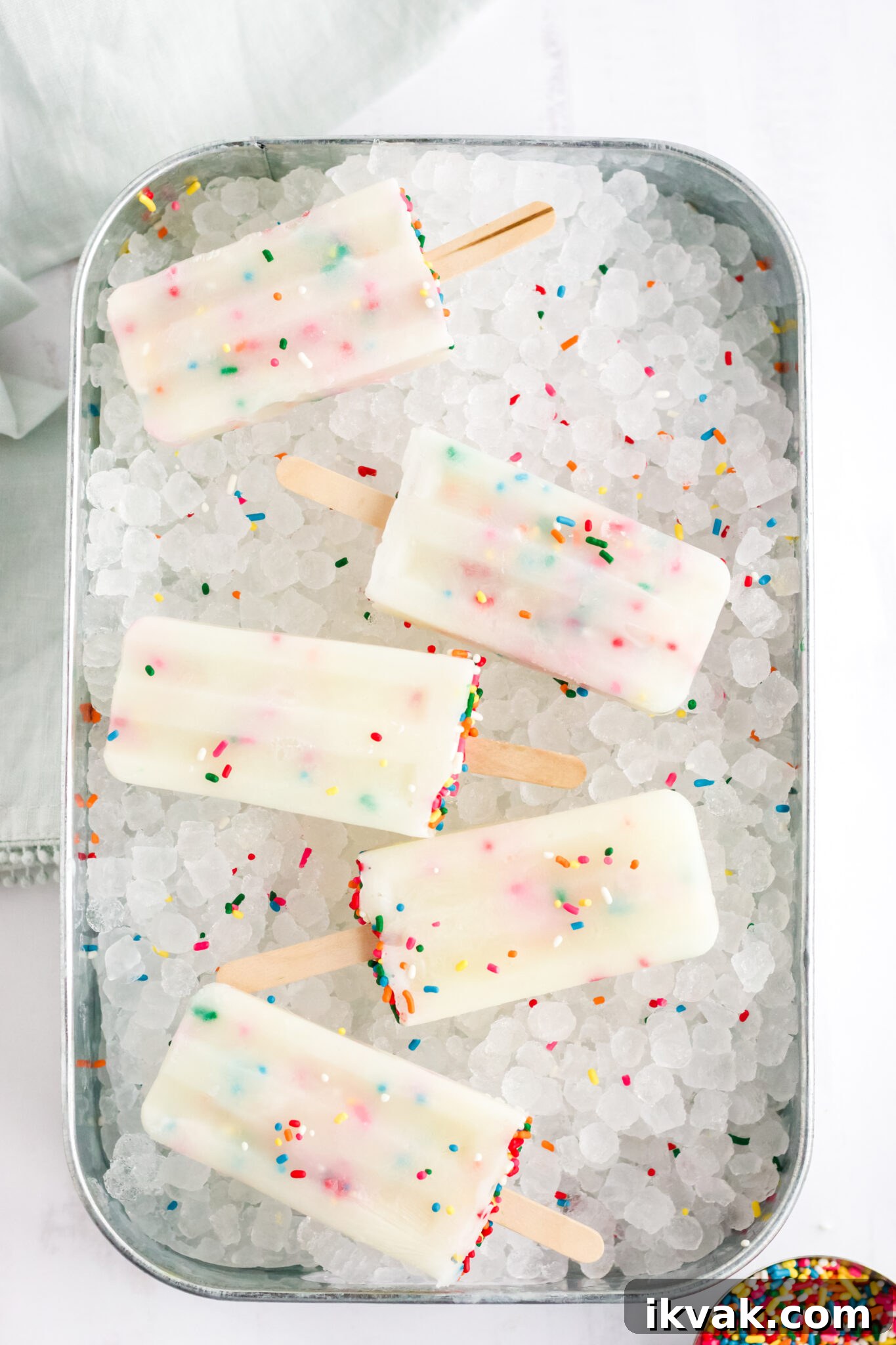 Funfetti Cake Batter Popsicles Recipe: Homemade Party Treat 3 funfetti cake mix popsicles on tray of ice
