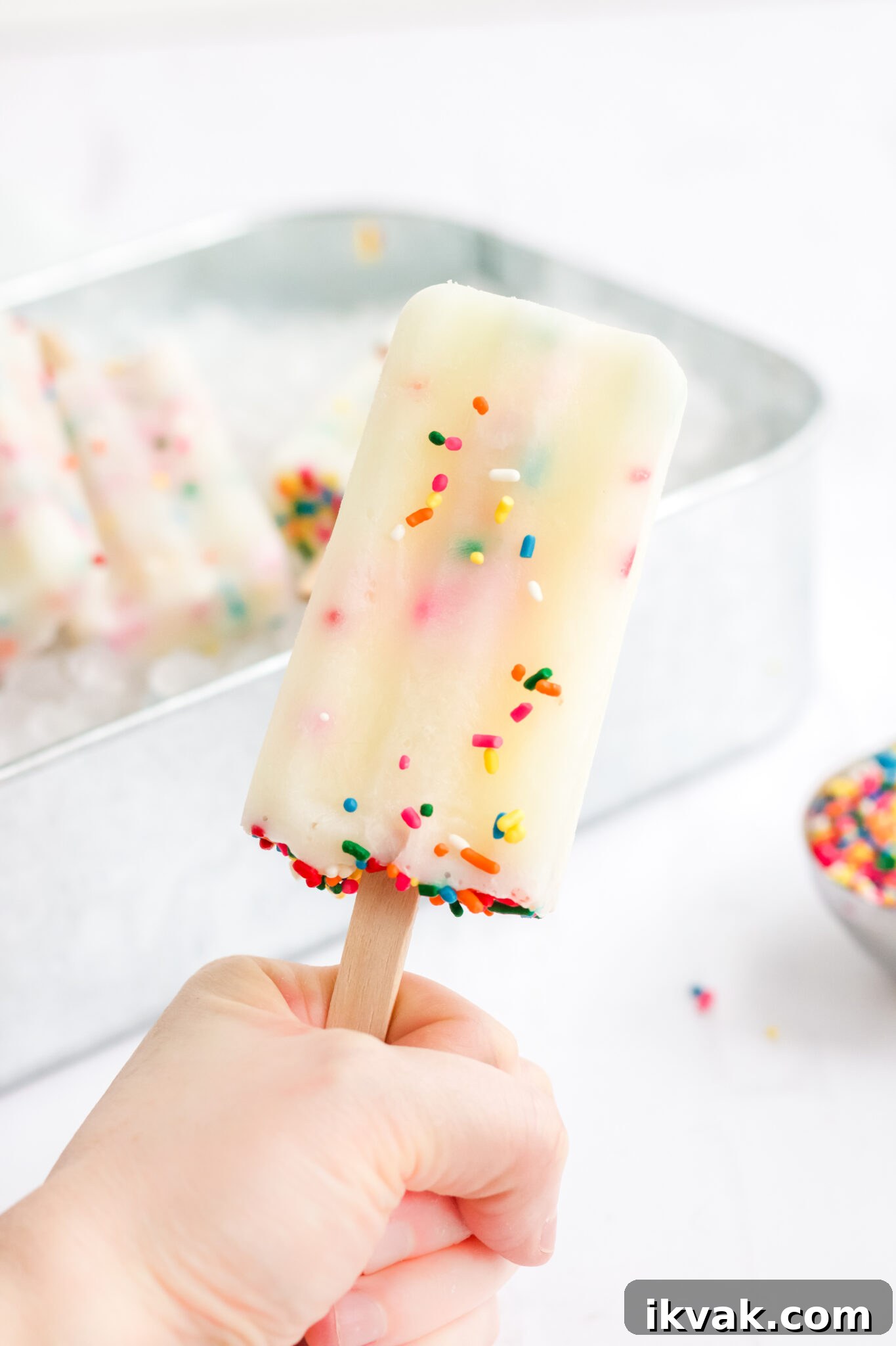 Funfetti Cake Batter Popsicles Recipe: Homemade Party Treat 7 hand holding funfetti cake mix popsicles