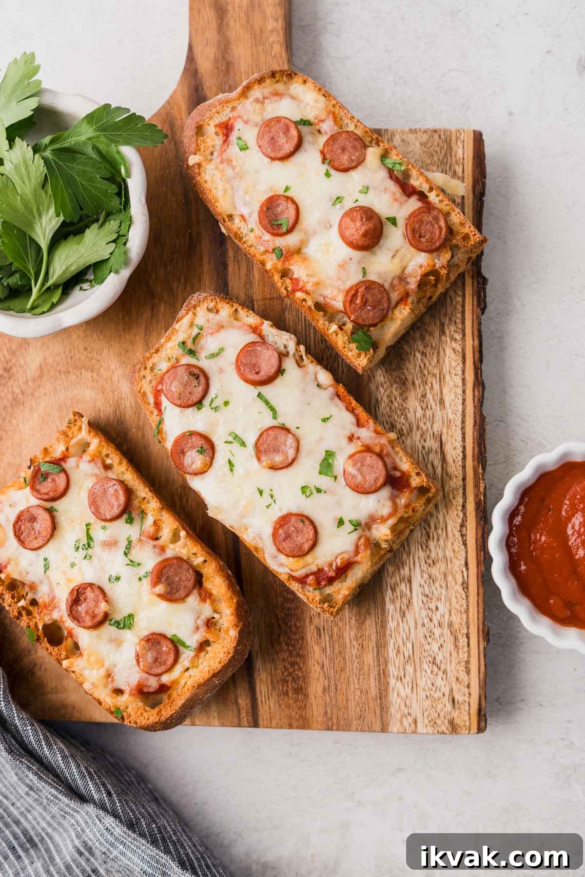 french bread pizza in the air fryer with pepperoni on a board.