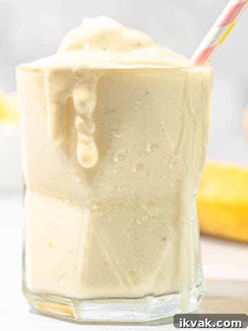 pineapple banana smoothie with bananas in background