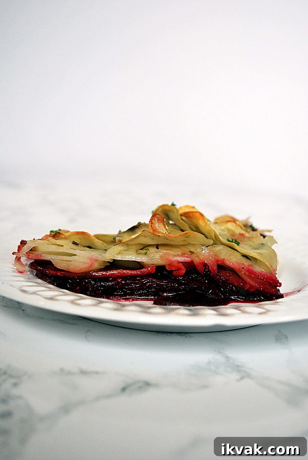 Potato and Beetroot Boulangère Recipe for Crispy Layered Potatoes 5 A slice of potato beet boulangere on a plate.