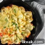 Potato and Beetroot Boulangère Recipe for Crispy Layered Potatoes 6 a close up view of potato beet boulangere in a cast iron skillet.
