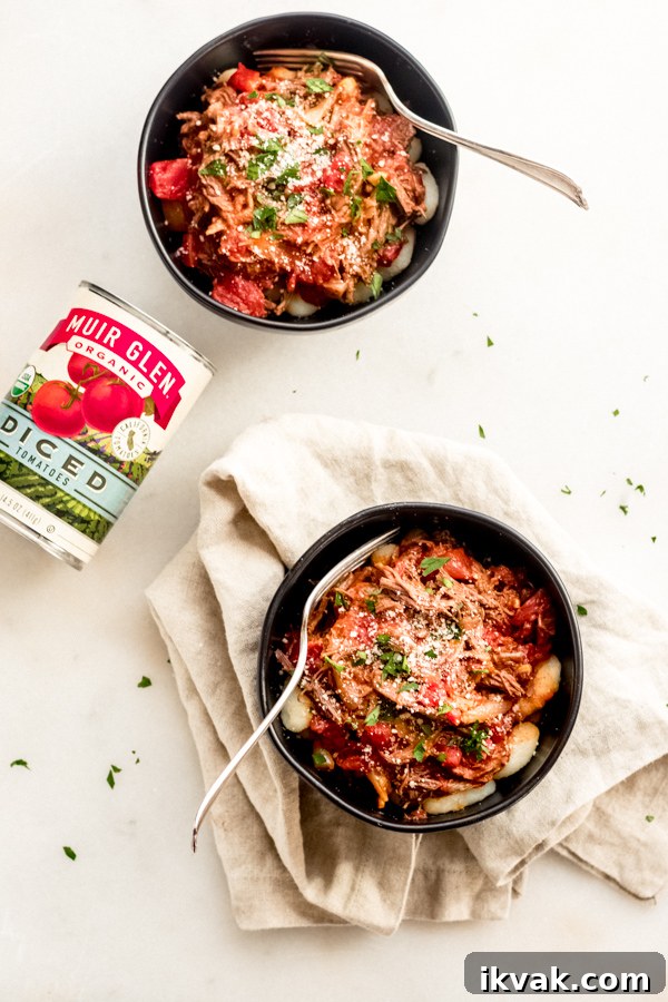 Braised beef with tomatoes and gnocchi in a bowl.