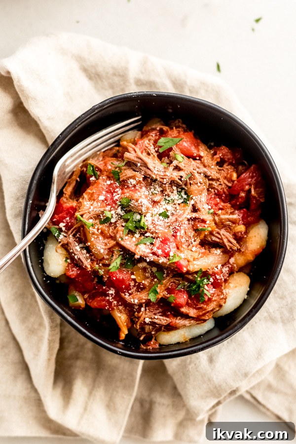 Braised beef with tomatoes and gnocchi in a bowl.