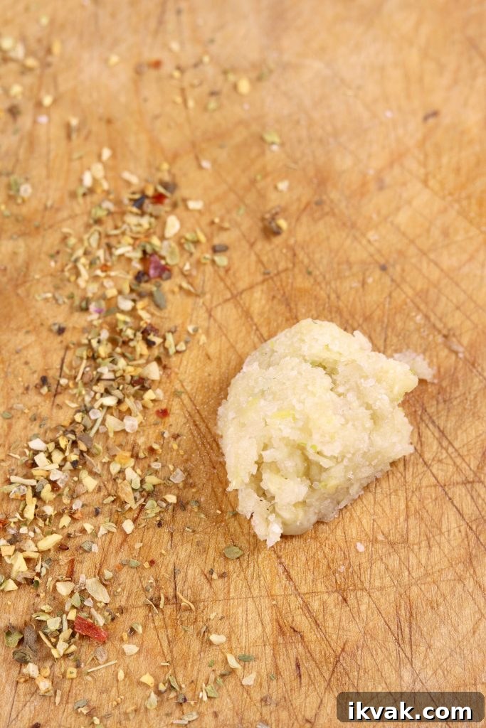 Making a garlic paste for salmoriglio sauce