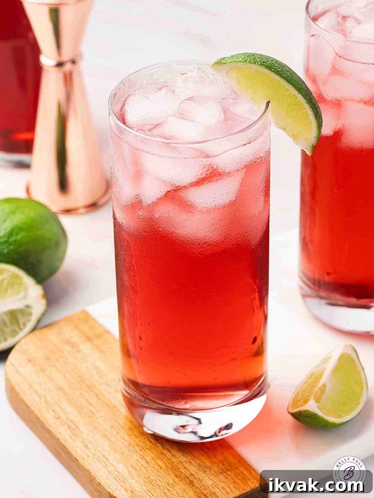 A woo woo cocktail garnished with a lime wedge