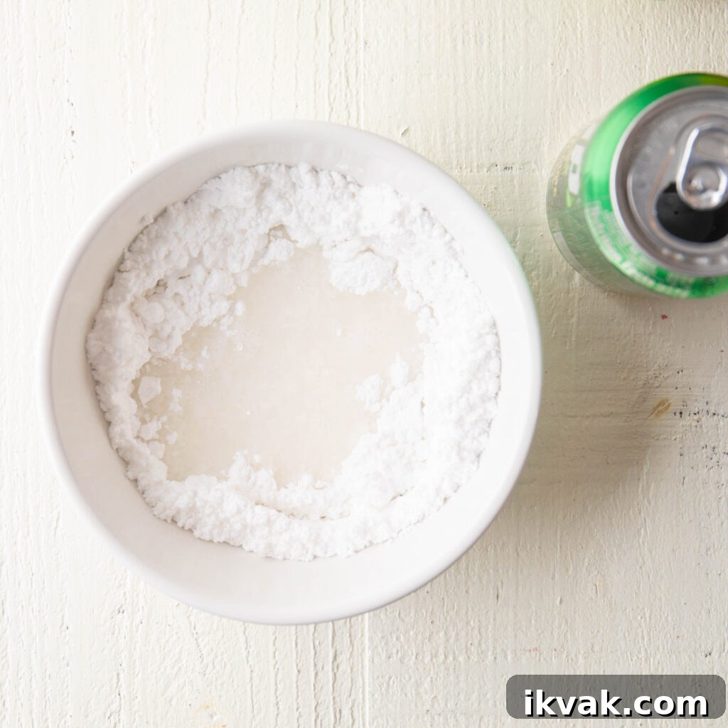 Moist 7-Up Pound Cake | Southern Soul Food Recipe 17 7-up soda and confectioners sugar in a small white mixing bowl
