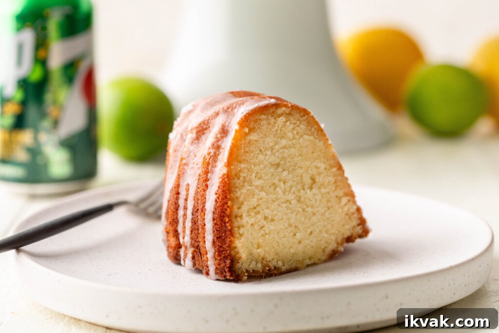Moist 7-Up Pound Cake | Southern Soul Food Recipe 19 slice of 7 up pound cake on white serving plate with can of 7 up, lemons and limes in the background