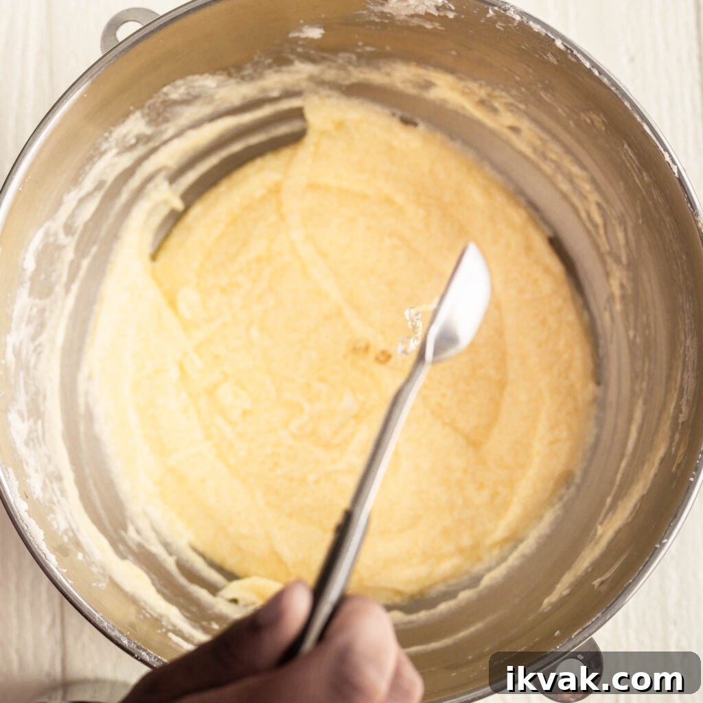 Moist 7-Up Pound Cake | Southern Soul Food Recipe 10 pouring lemon extract into butter and sugar mixture