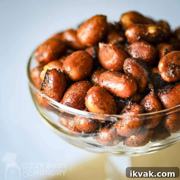 Close up shot of chipotle peanuts in a clear martini glass.