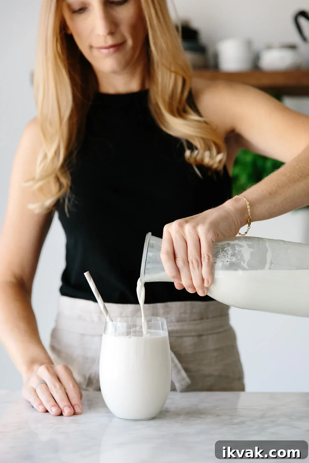 Cashew milk being poured into a glass